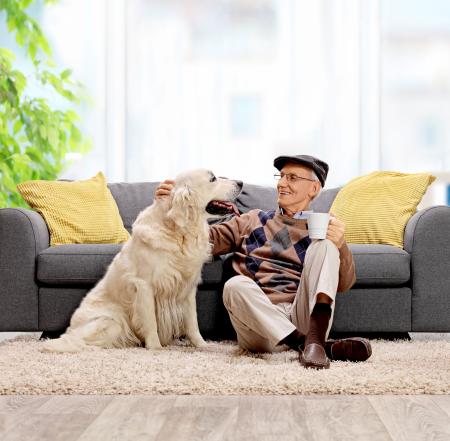 man and dog sitting on the floor